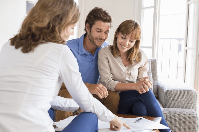 Couple reviewing paperwork with professional Couple reviewing paperwork with professional